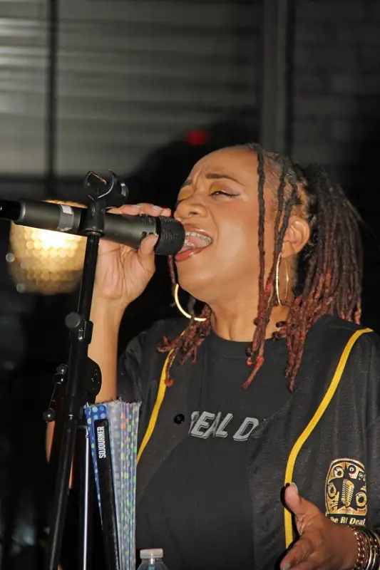 Dre Dixon performing with The Real Deal