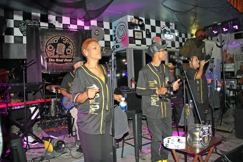 The Real Deal performing together onstage